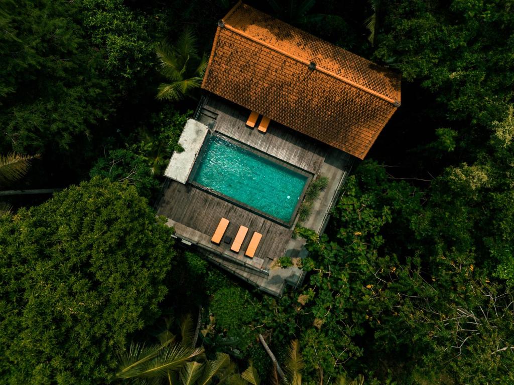 an overhead view of a building with a swimming pool at Umah Temuku Ubud in Ubud