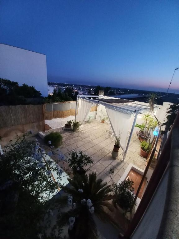 a view of a patio at night with plants at vacanza nel salento1 in Matino