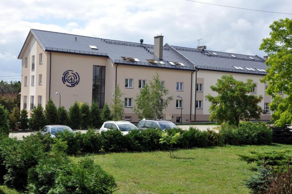 a building with cars parked in front of it at MCEW Studnia in Płock