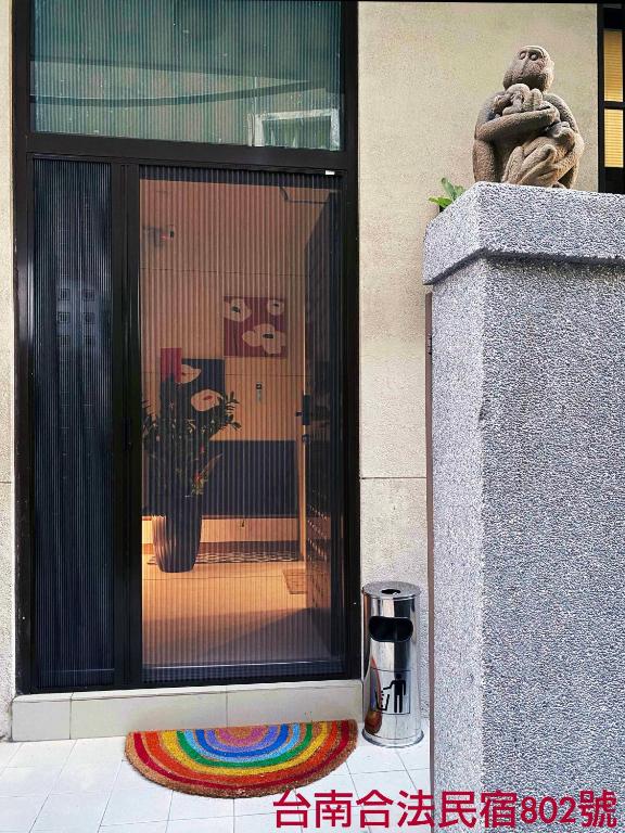 a window of a building with a motorcycle in it at 1881 Ya ka Hostel in Tainan
