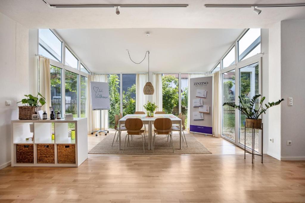 a dining room with a table and chairs at Blaues Haus in Buchloe