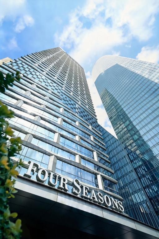 a tall building with the words four seasons at Four Seasons Hotel Tianjin in Tianjin