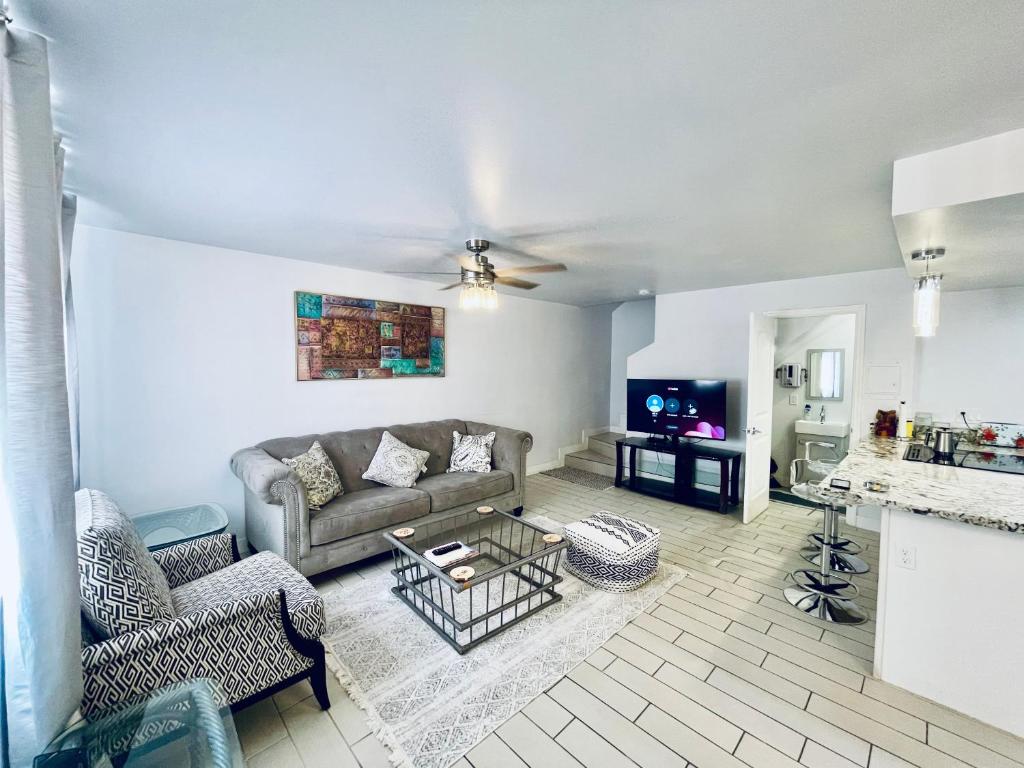 a living room with a couch and a tv at Hopes Cozy Condo in Phoenix