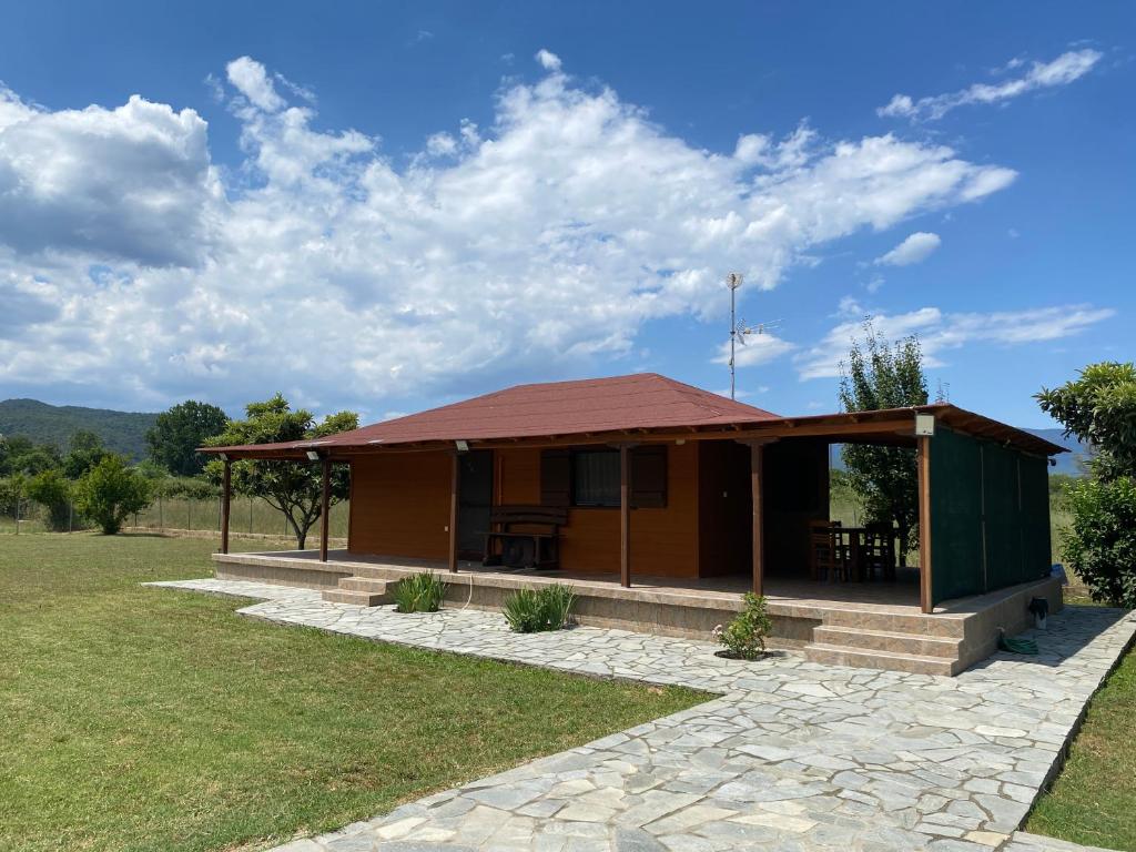 a small building with a roof on a field at Garden Villa in Stavros