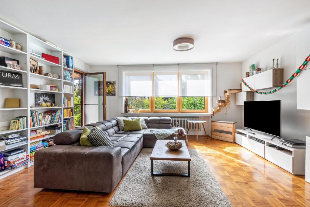 a living room with a couch and a tv at Ferienwohnung Laura in Illertissen