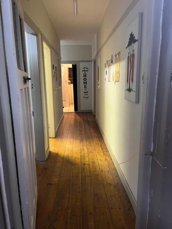 a hallway with a hard wood floor and a hallway with at Willow whispers in Gqeberha