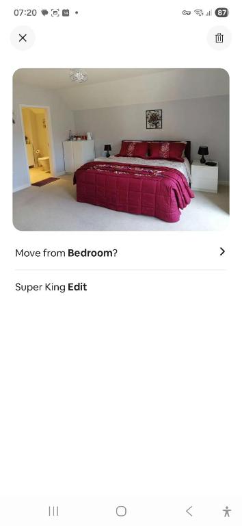 a bedroom with a bed with a red blanket at Spacious Luxury Room in Brixham