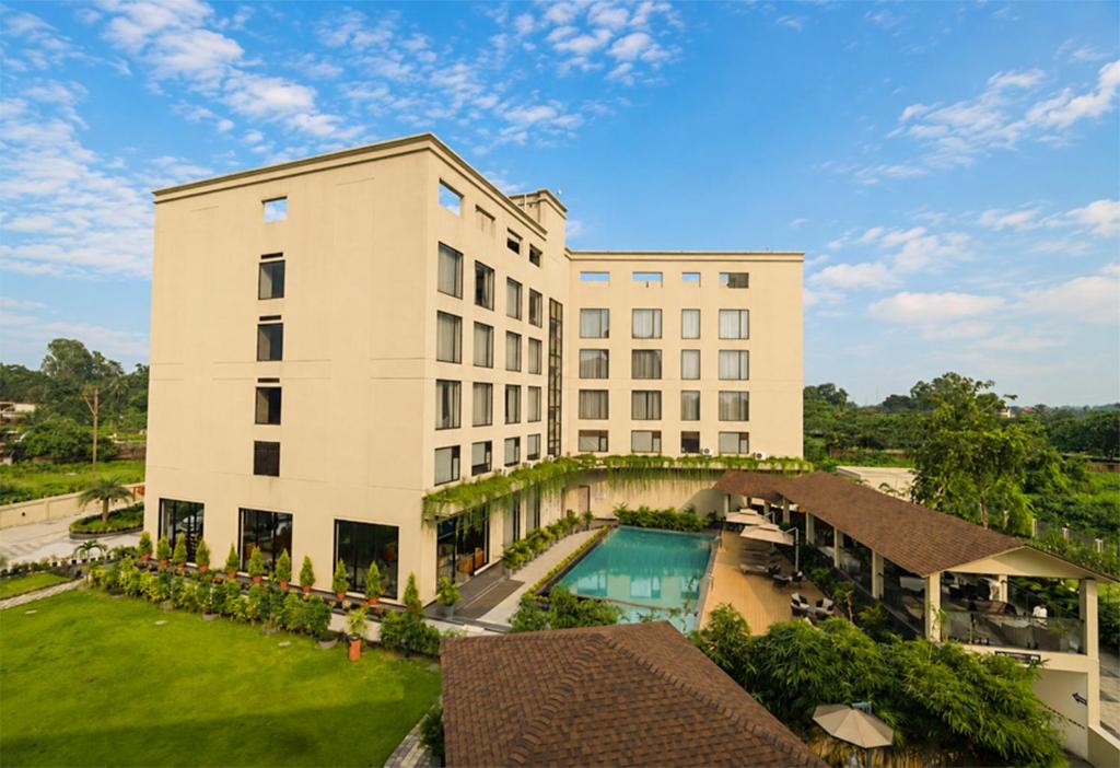 an aerial view of a building with a swimming pool at Aurum by R J Resorts in Siliguri