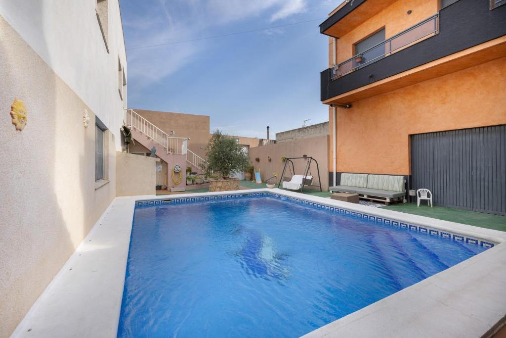 a swimming pool in front of a building at MM Delta Holidays in El Lligallo del Gànguil
