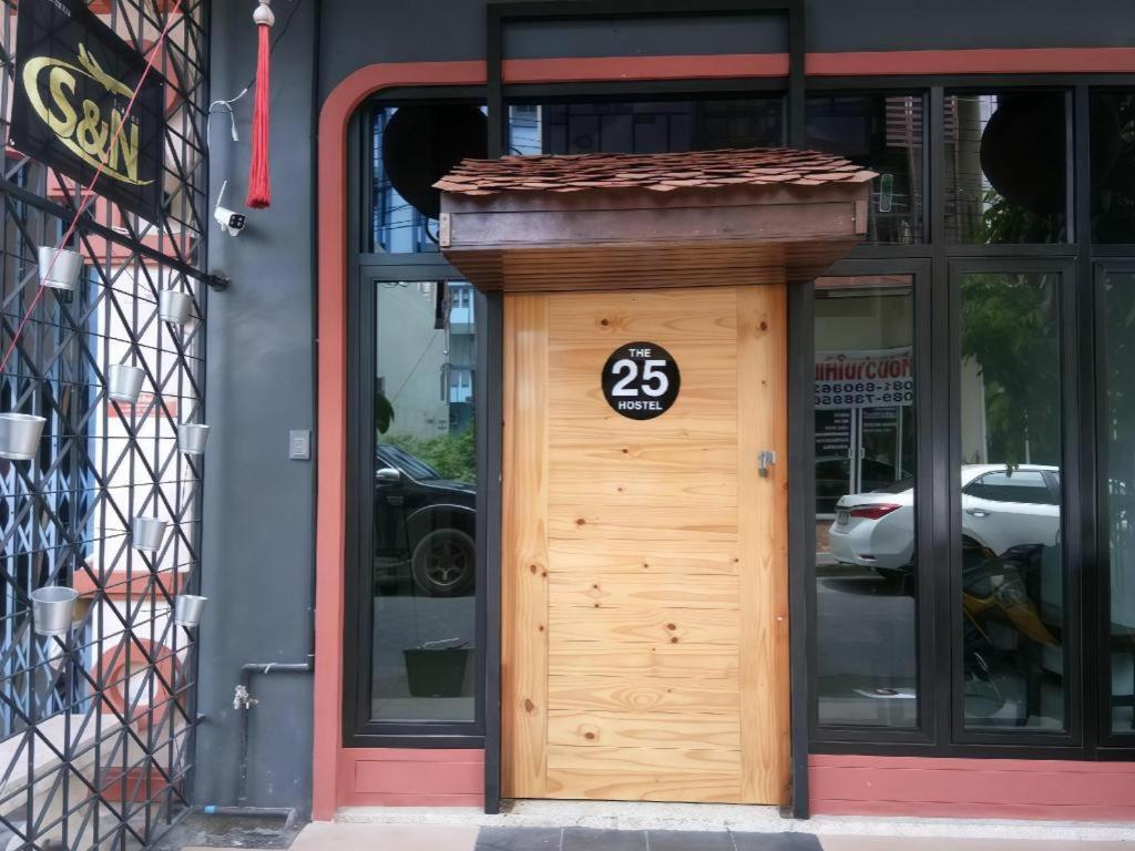 a wooden door with the number on it at The 25 Hostel in Sathani Khlong Rian
