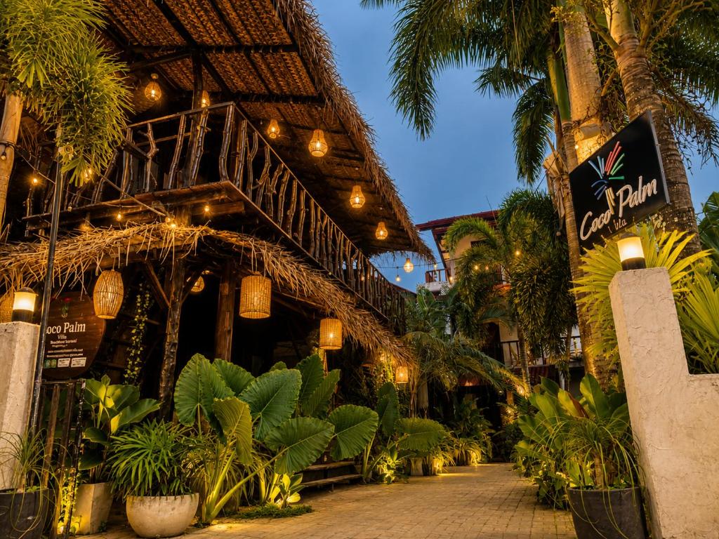 a building with a bunch of plants and lights at Coco Palm Villa and Cabanas in Tangalle