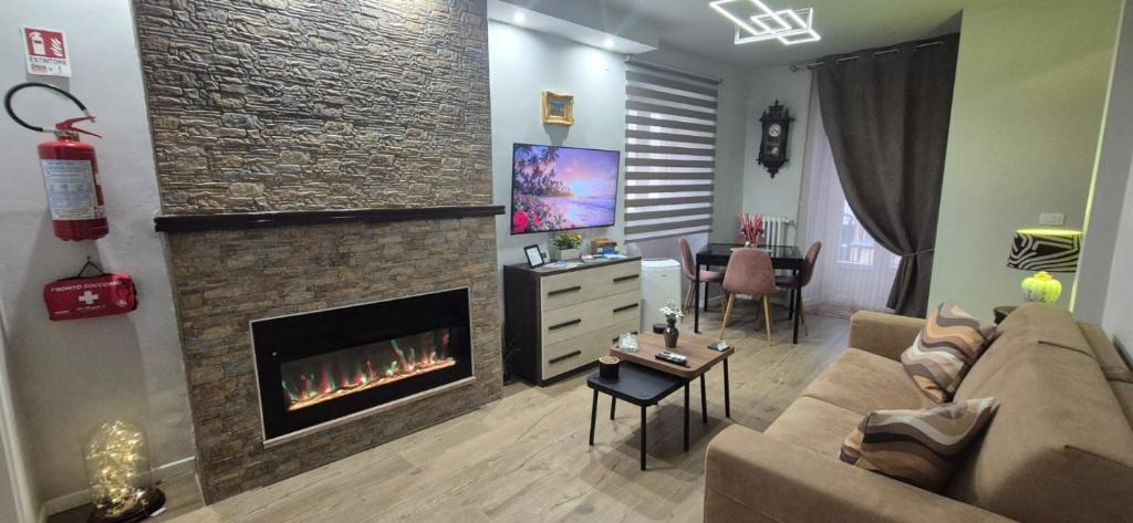 a living room with a couch and a fireplace at Casa di Clara in Sulmona