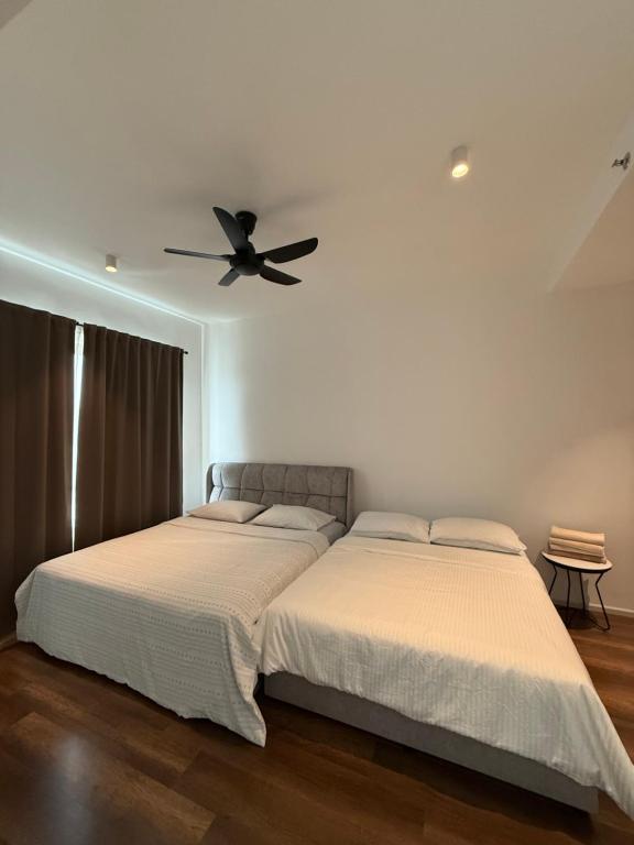 a bedroom with two beds and a ceiling fan at Ipoh Peaceful Onsen 1 BR Lost World Tambun in Tambun