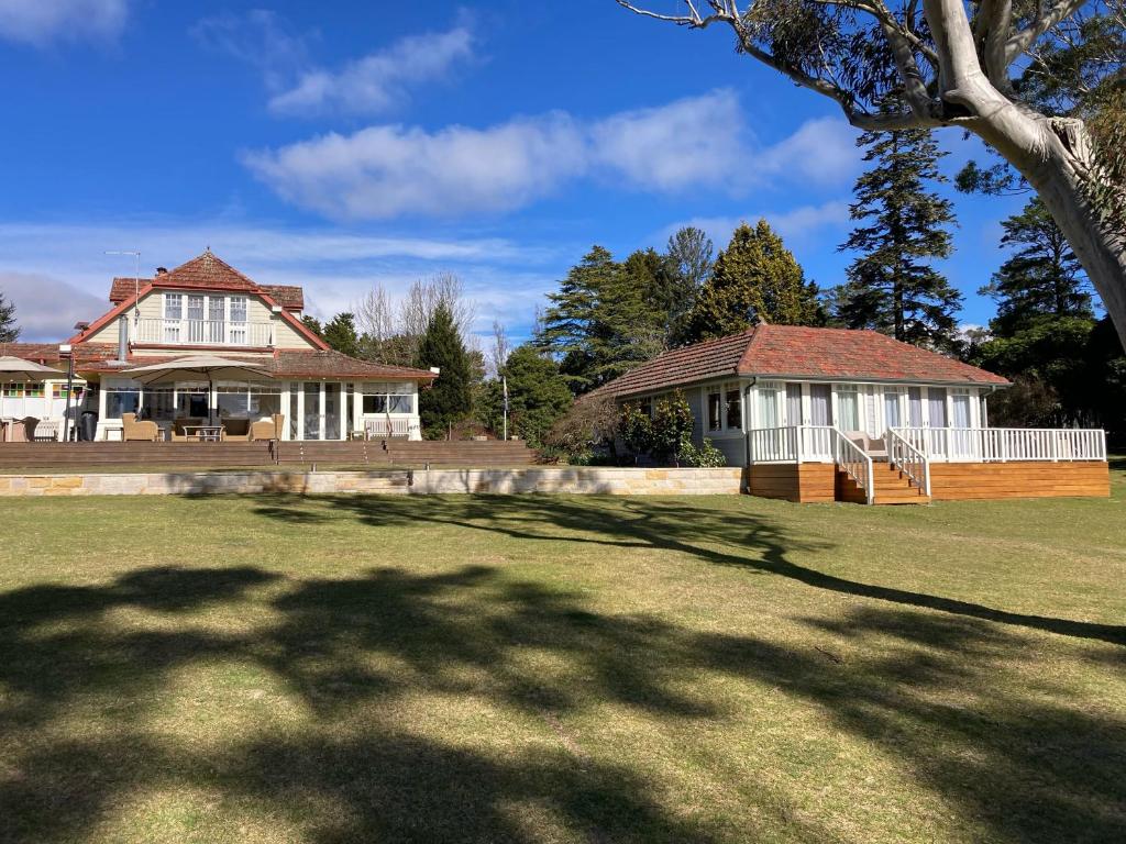 a large house with a large yard with a building at Mount Booralee Estate in Blackheath