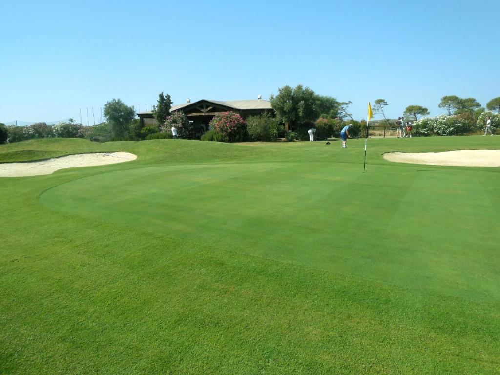 a view of a golf course with a green at Sa Tirìa in Chia