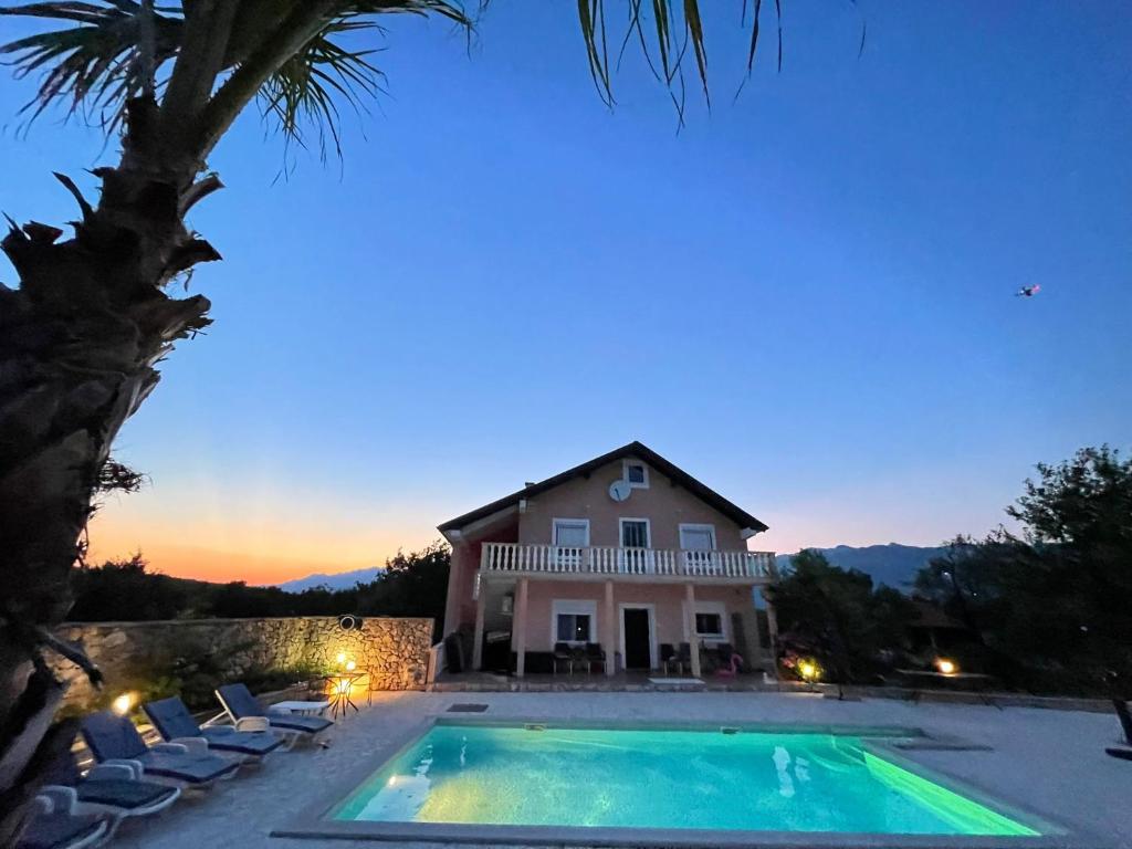 a house with a swimming pool in front of a house at Villa Canyon Escape 12 Personen in Bilišane