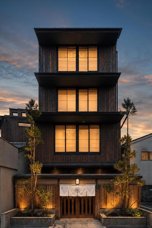 a house with a wooden facade with windows at MR T Kamogawa East 12 in Kyoto
