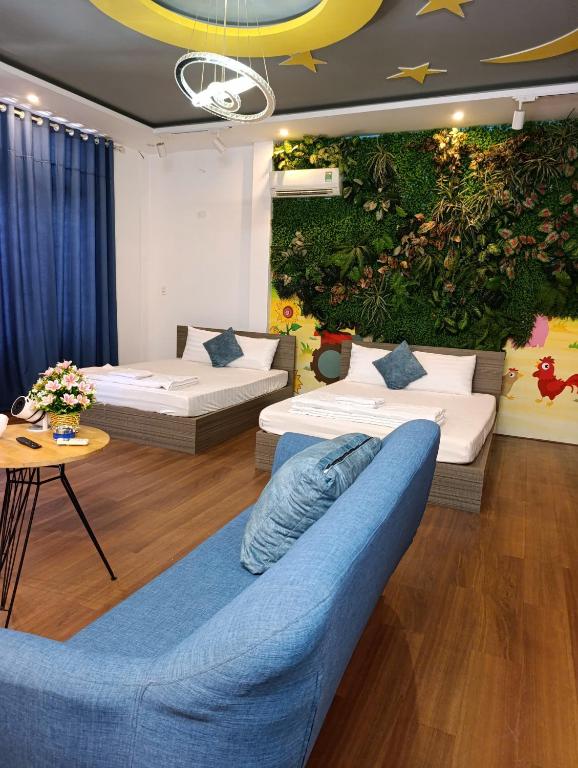 a living room with two beds and a couch at QN Home in Quy Nhon