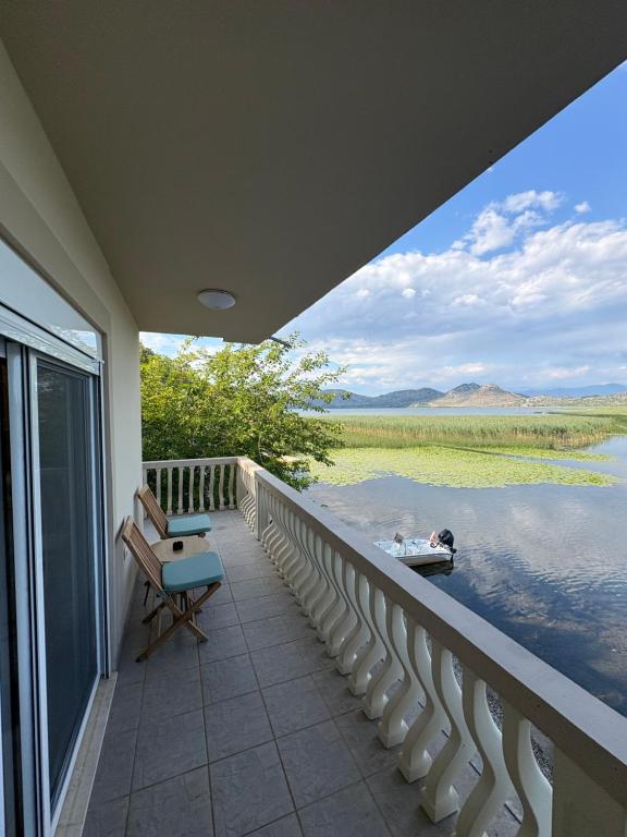 a balcony of a house with a view of the water at Lakeside house in Podgorica