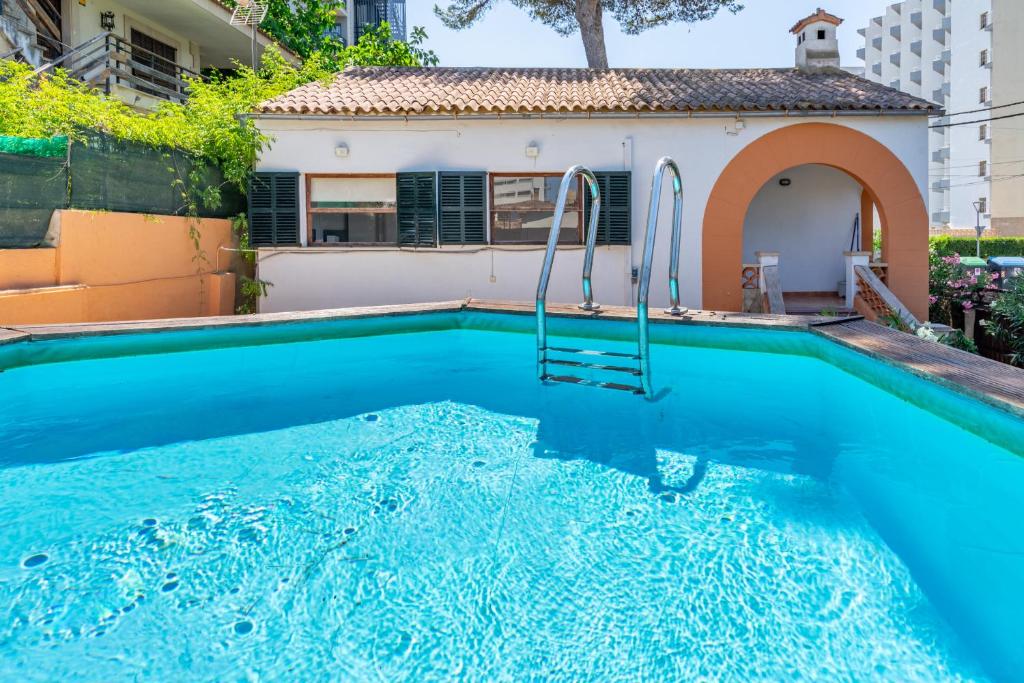 a swimming pool in front of a house at Llinya 7 in El Arenal