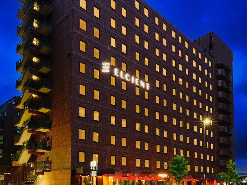 a tall black building with lights on at Hotel Elcient Kyoto Hachijoguchi in Kyoto