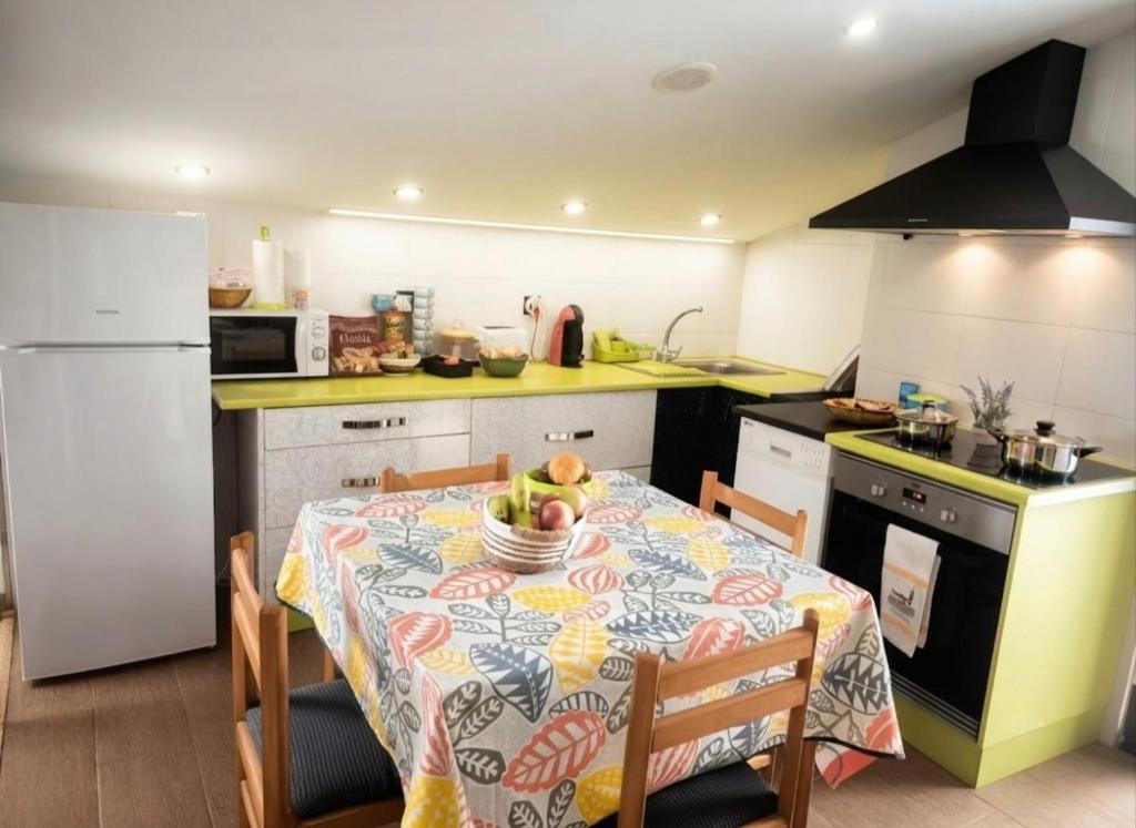 a kitchen with a table with a table cloth on it at Casa Evita in Sanxenxo