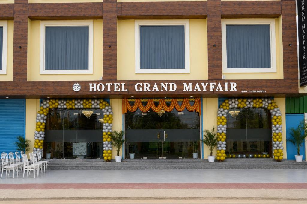a hotel grand mayar with chairs in front of it at Hotel Grand Mayfair in Dimapur