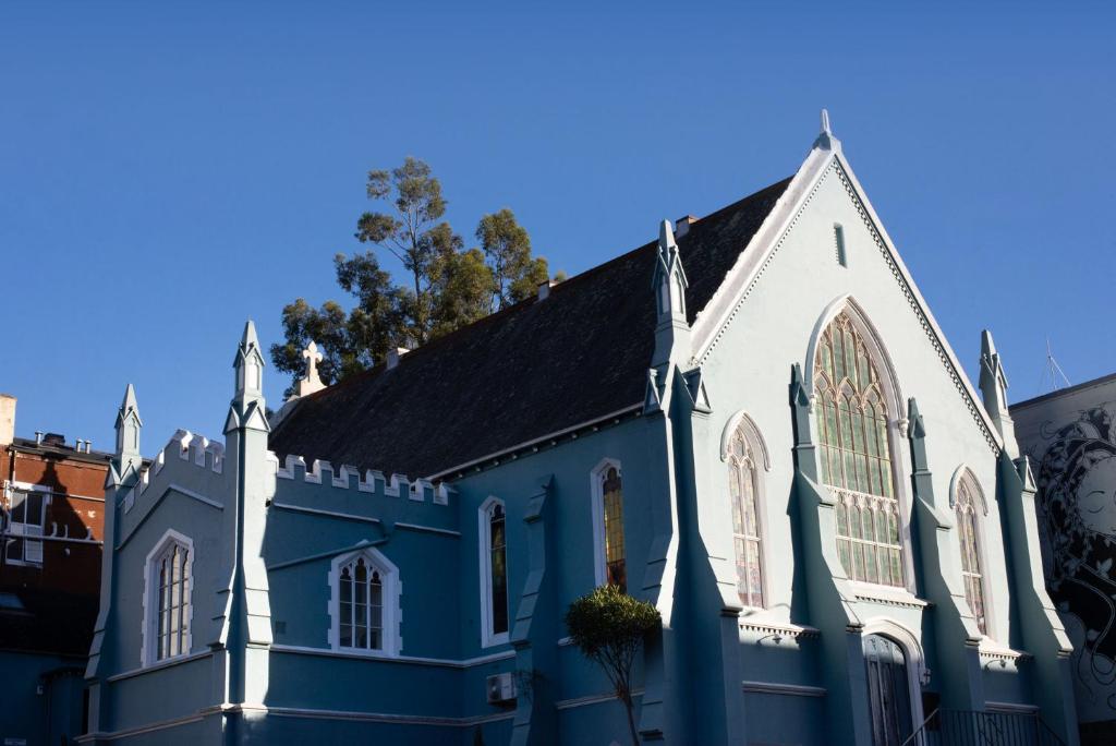 a blue and white church on a street at Chapel Apartments in Dunedin