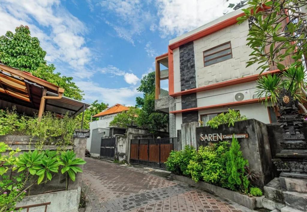 a house with a sign on the side of a street at Saren Guesthouse Bali in Kerobokan
