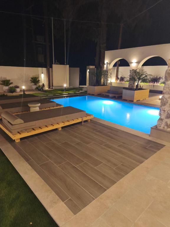 a large swimming pool at night with a pool at Villa Sivo in Kolymbia