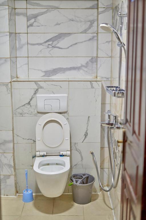 a bathroom with a toilet and a shower at RÉSIDENCE Chloé in Bonamoussadi