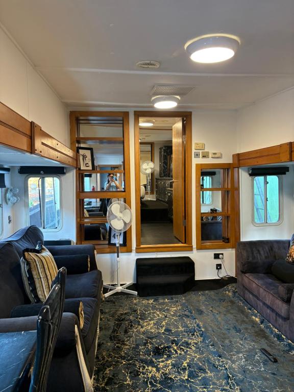 a living room with couches and a mirror at Winnie baygo Meadow view in Hurst