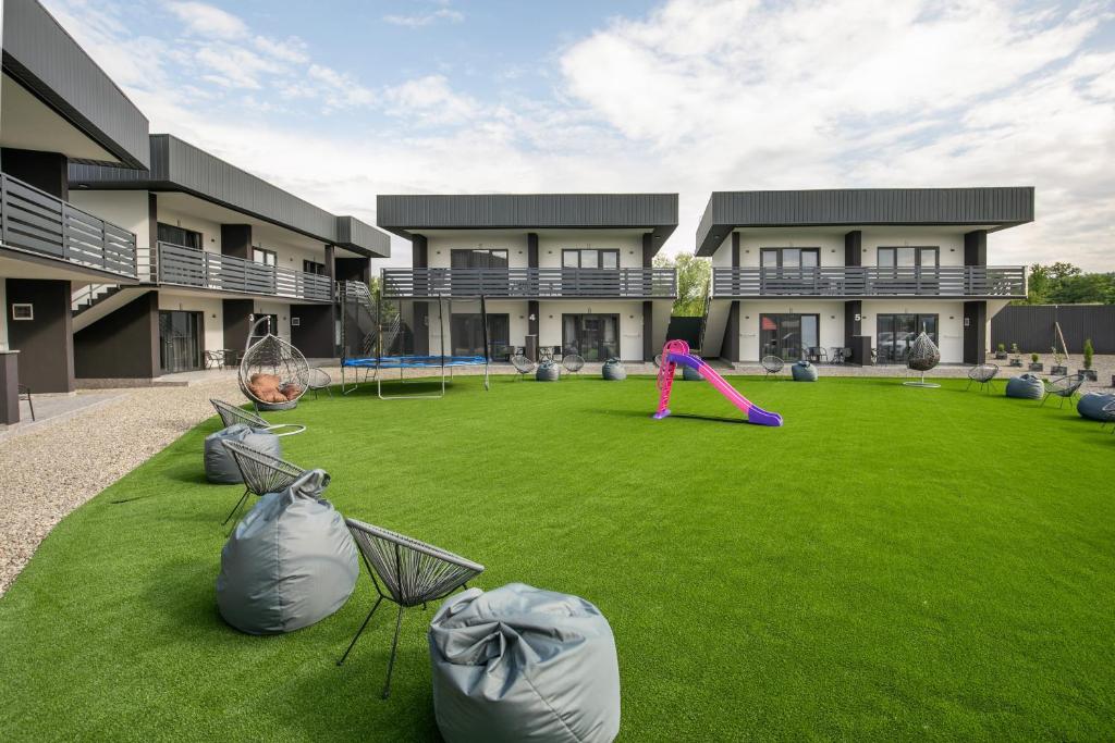 a building with a large yard with a playground at SALTERRA Resort in Solotvyno