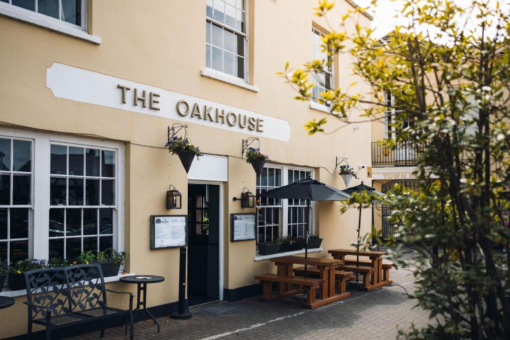 a restaurant with tables and chairs outside of a building at Oak House Hotel in Axbridge