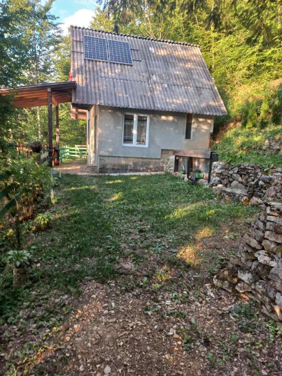 a small house with solar panels on the roof at Vikend kuća Zlatarski DAR in Nova Varoš