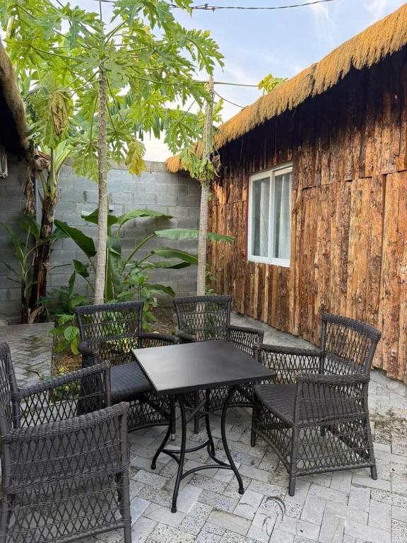 a patio with a black table and chairs at Đức Hòa homestay in Ấp Thố Mố (1)