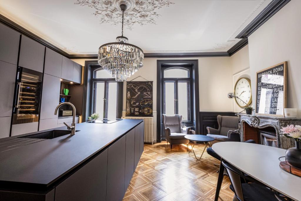 a kitchen with a large island and a dining room at Le Duval 66 in Pontarlier
