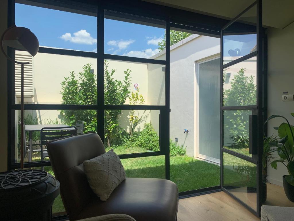 a living room with a large window and a chair at Sol 41 in Bragança