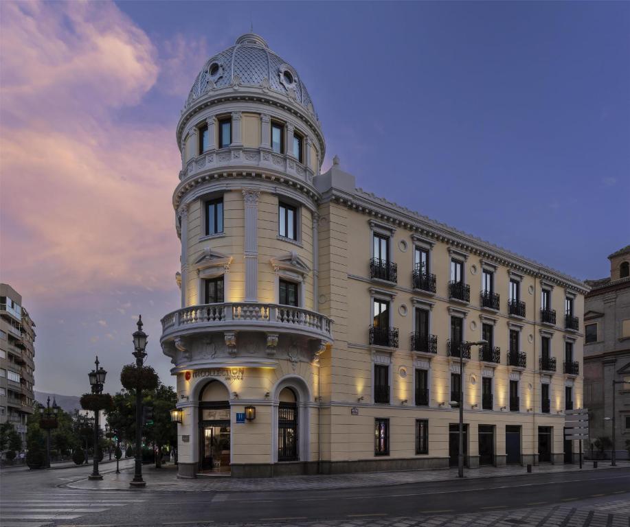 a building with a tower on top of it at NH Collection Victoria in Granada