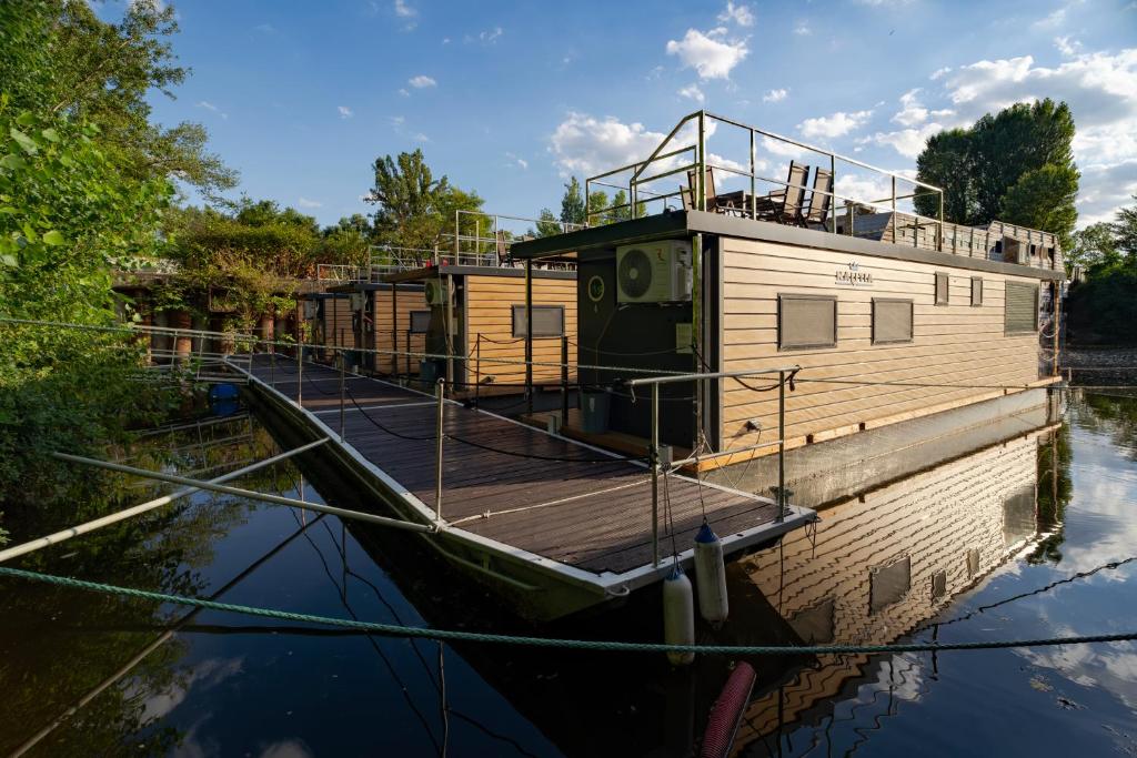 a house boat is docked on the water at Prague River Houseboats - Private Bay in Prague