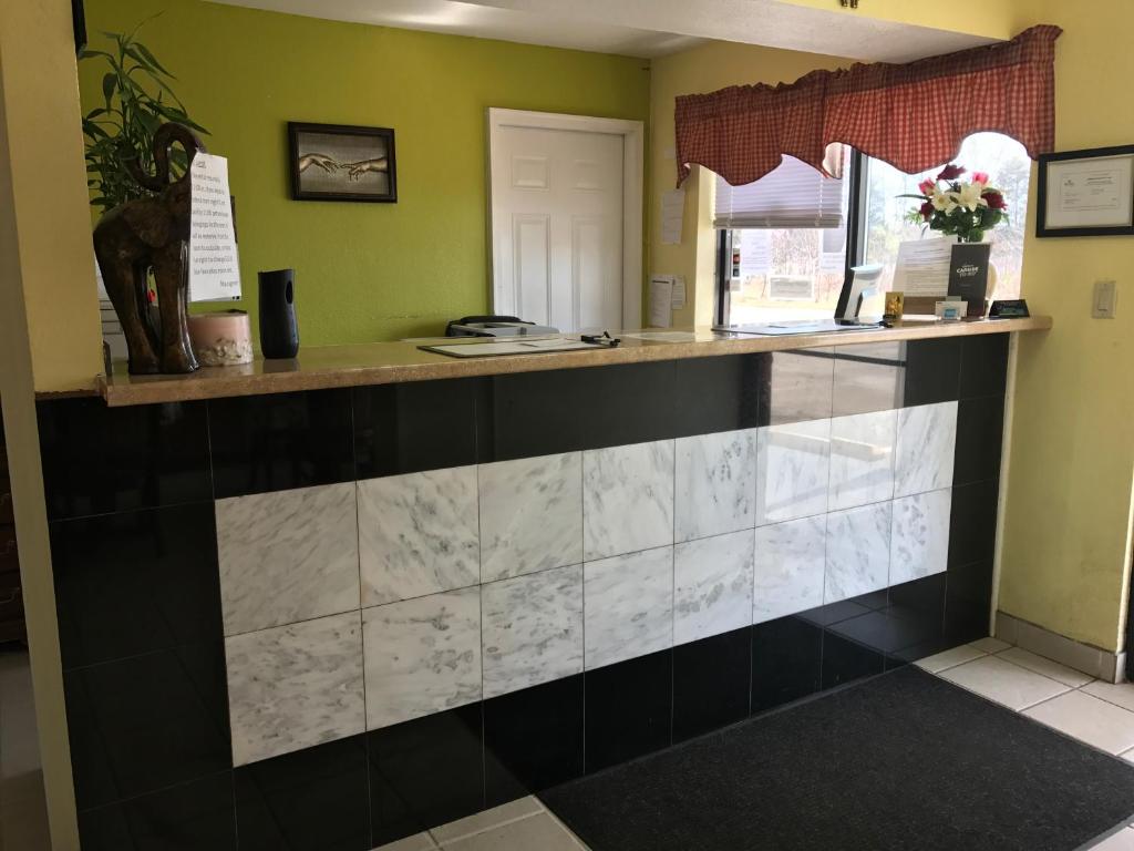 a counter in a restaurant with a tile wall at Royal Regency Inn in Rock Hill