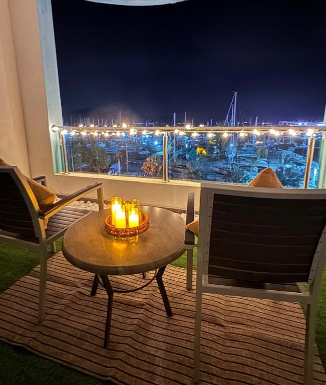 a table and chairs on a balcony with a view of a harbor at Silver Place Marina Island Lumut in Lumut