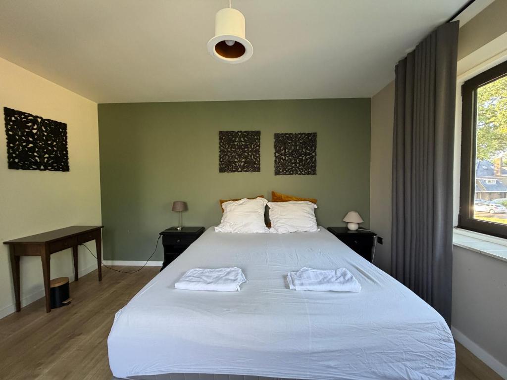 a bedroom with a large bed with two towels on it at Apartment Osso 3 in Arnhem