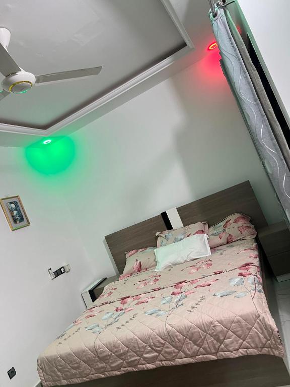 a bedroom with a bed in a room with avertisementatronatronstration at TGS home in Lomé