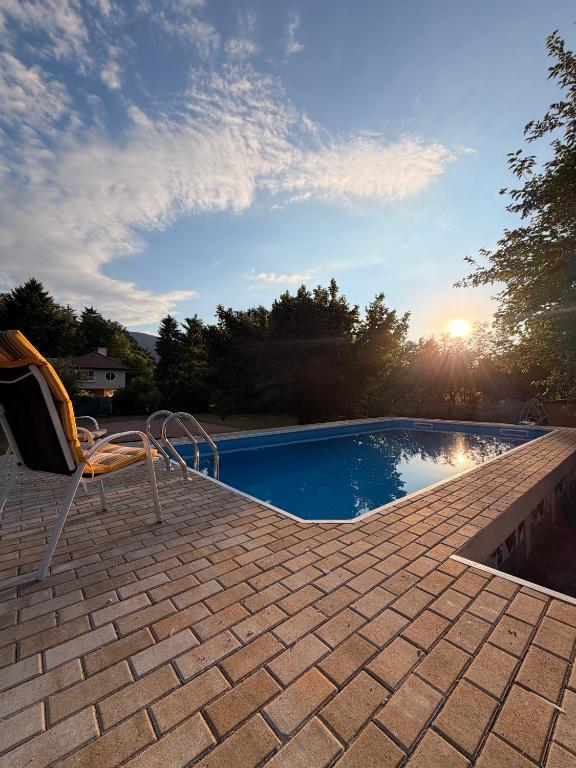 a swimming pool with a chair sitting next to it at Vila Noor Sarajevo in Sarajevo