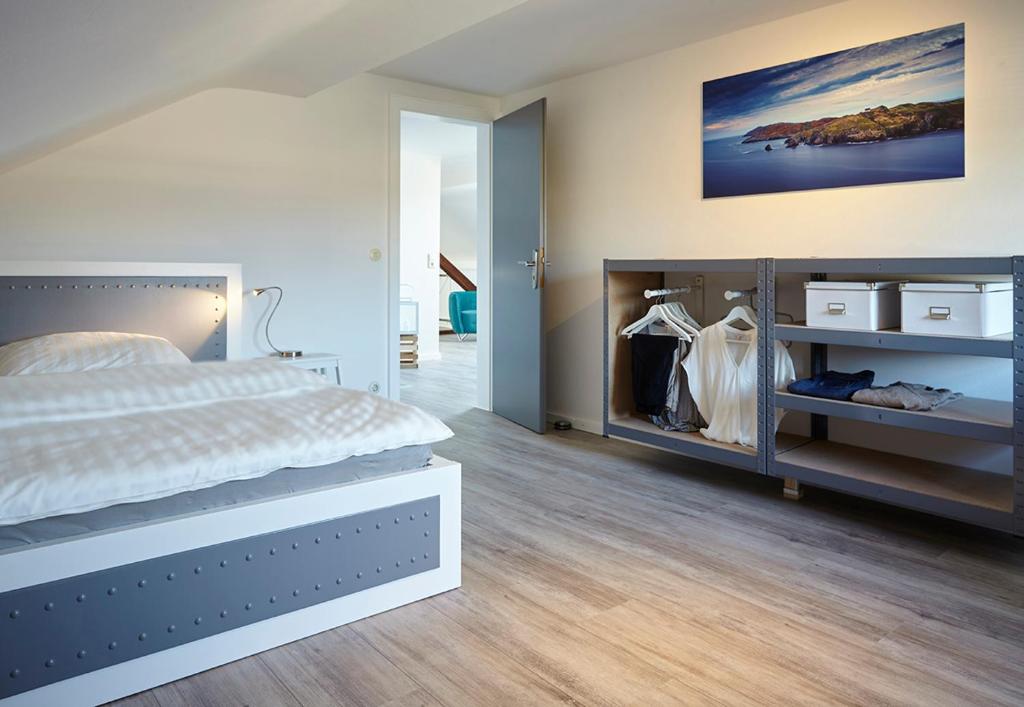 a bedroom with a large bed and a closet at Ferienwohnung Schwarz in Mayen