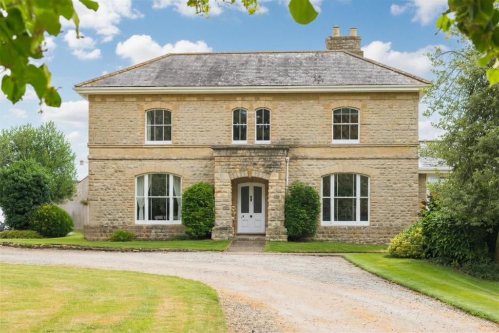 a large brick house with a driveway at Finest Retreats - Walltree House in Brackley