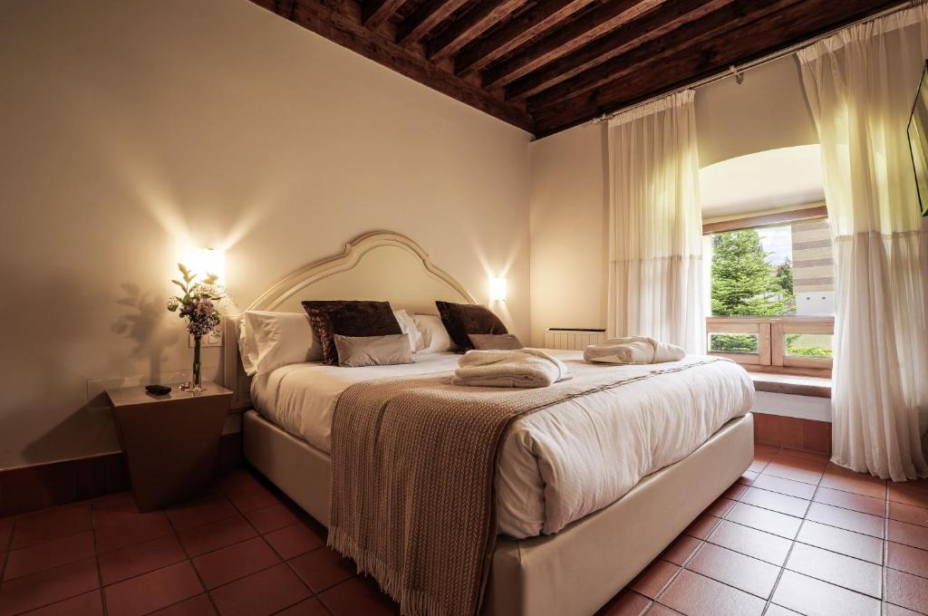 a bedroom with a large bed and a window at Hotel San Antonio el Real in Segovia