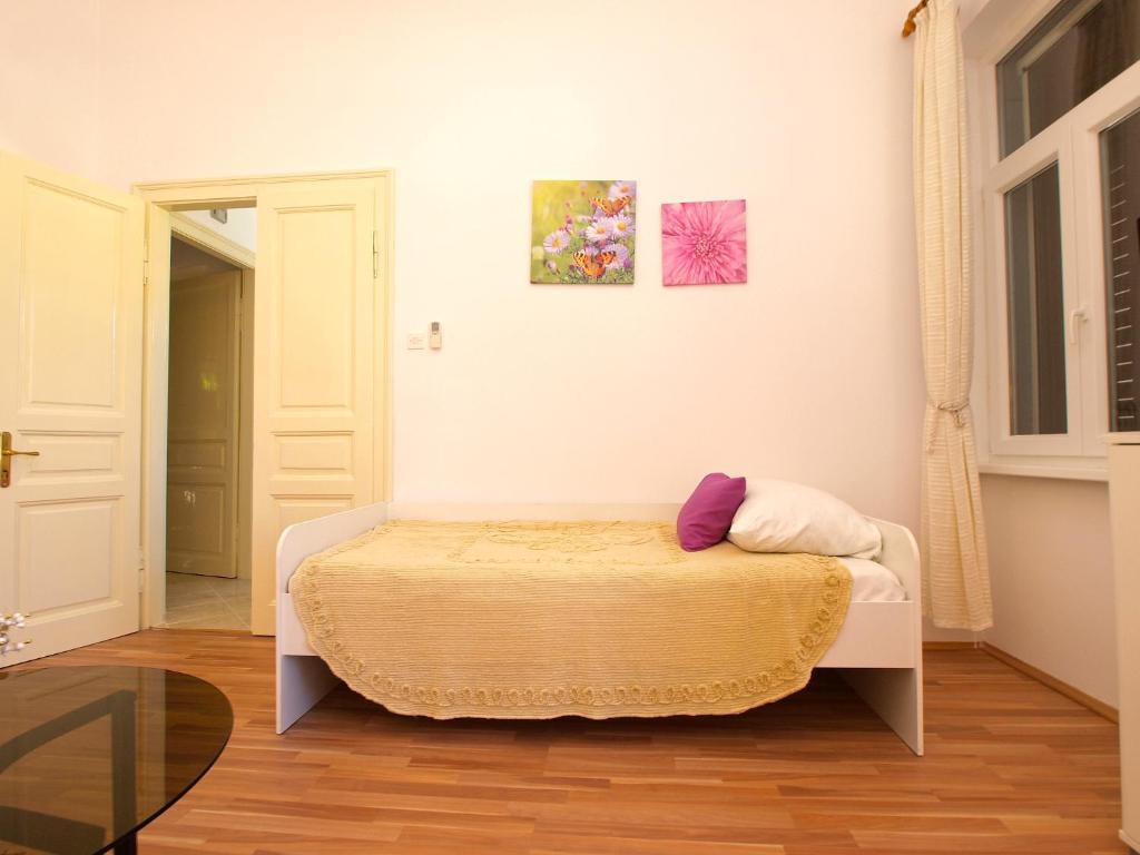 a small bedroom with a bed in a room at Apartment by the sea Rabac 1093 in Rabac