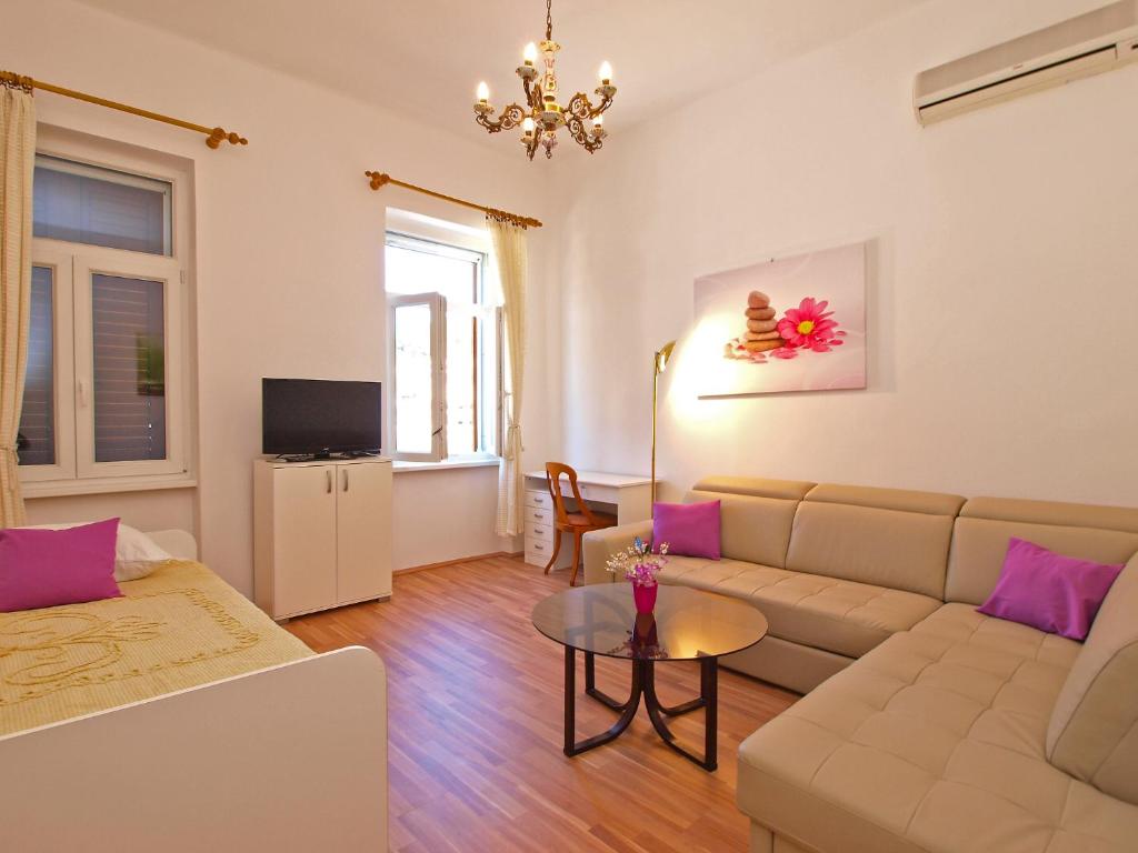 a living room with a couch and a table at Apartment by the sea Rabac 1093 in Rabac